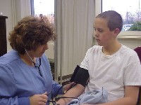 Ms. Cossette 
checking blood pressure